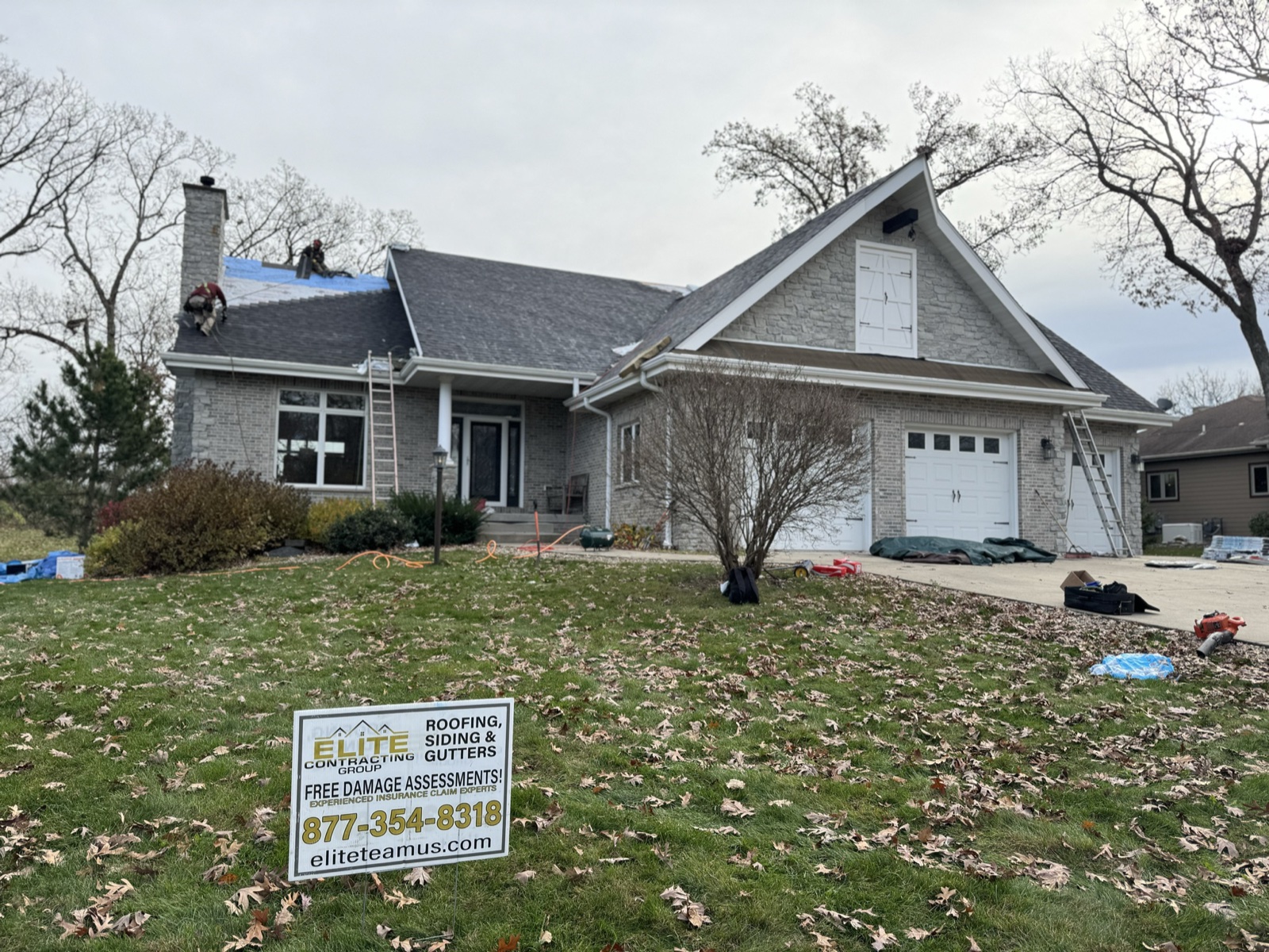 Elite Contracting Group crew working a Stateline roof replacement, mid-install