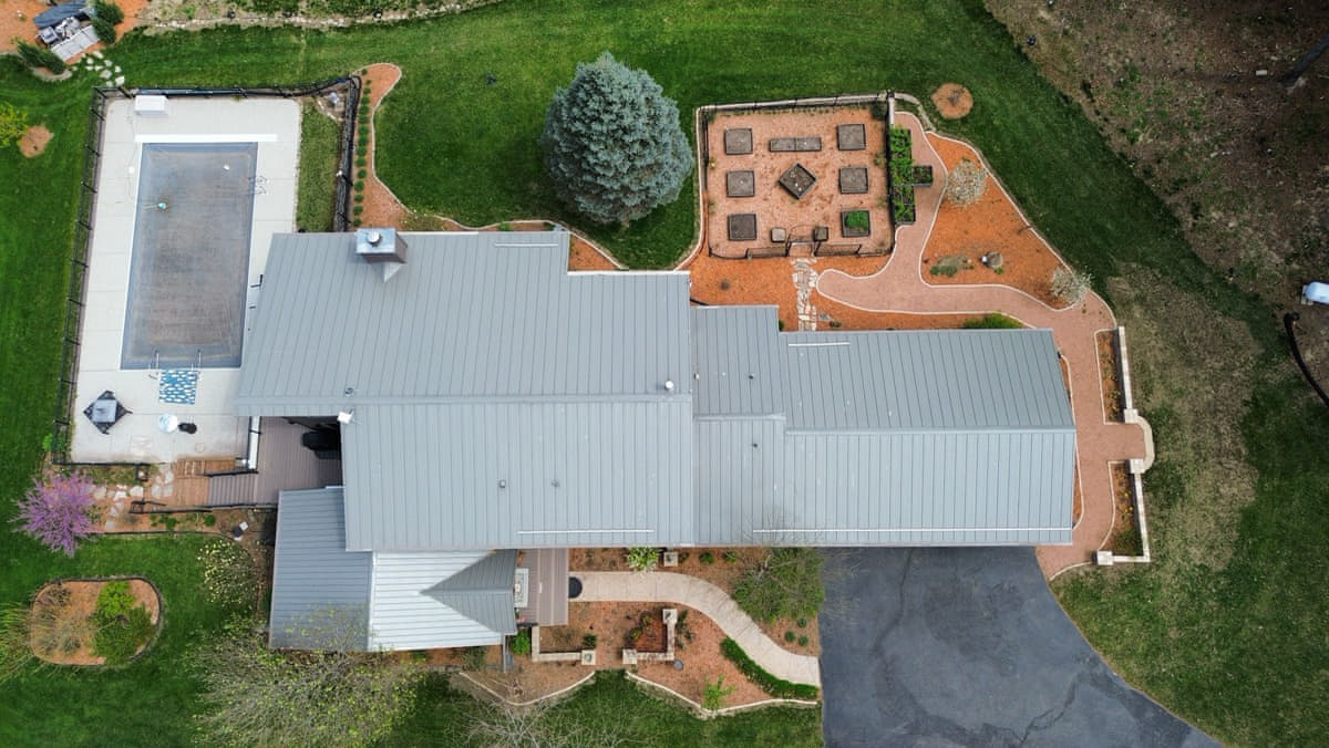 Aerial drone shot of a ranch-style home in Edgerton, WI with an aged, weathered roof before standing-seam metal roof replacement