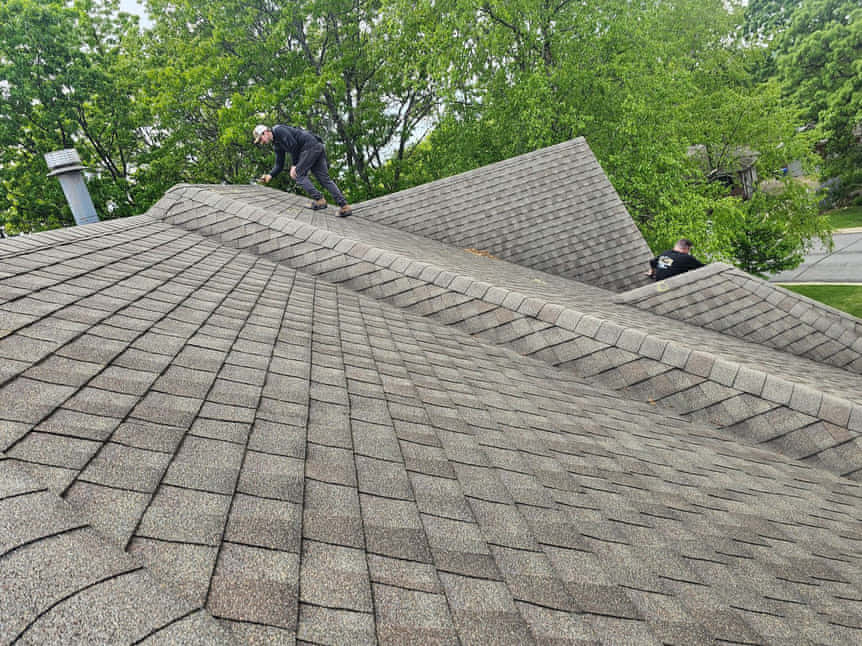An insurance adjuster on the roof with our team