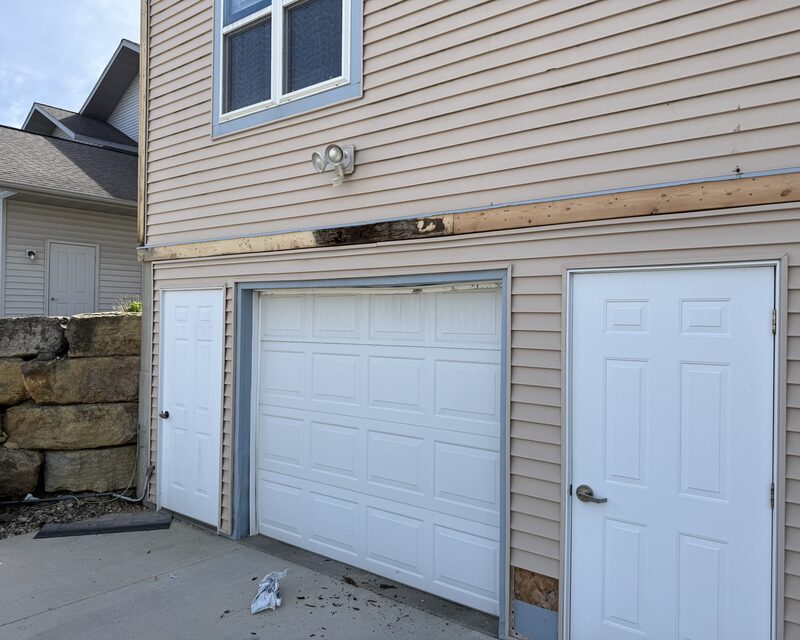Rotted exterior trim above a garage door removed for wood rot repair, new wood and flashing installed, Madison WI