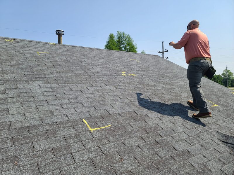 Chalk-marked hail damage on asphalt shingles during a Belvidere IL storm damage roof inspection
