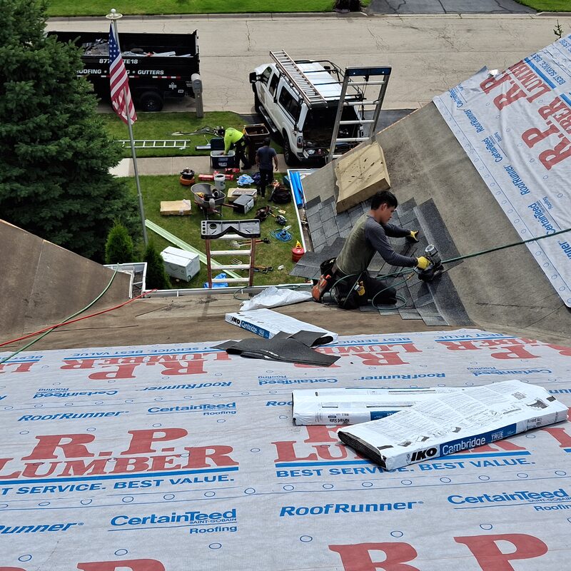 Elite crew installing an asphalt shingle roof replacement on a Belvidere IL home with IKO Cambridge shingles