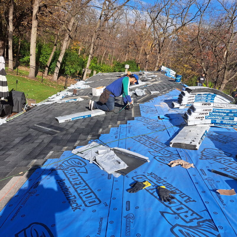 Roof replacement in progress on a Loves Park IL ranch with IKO Cambridge asphalt shingles going down over synthetic underlayment