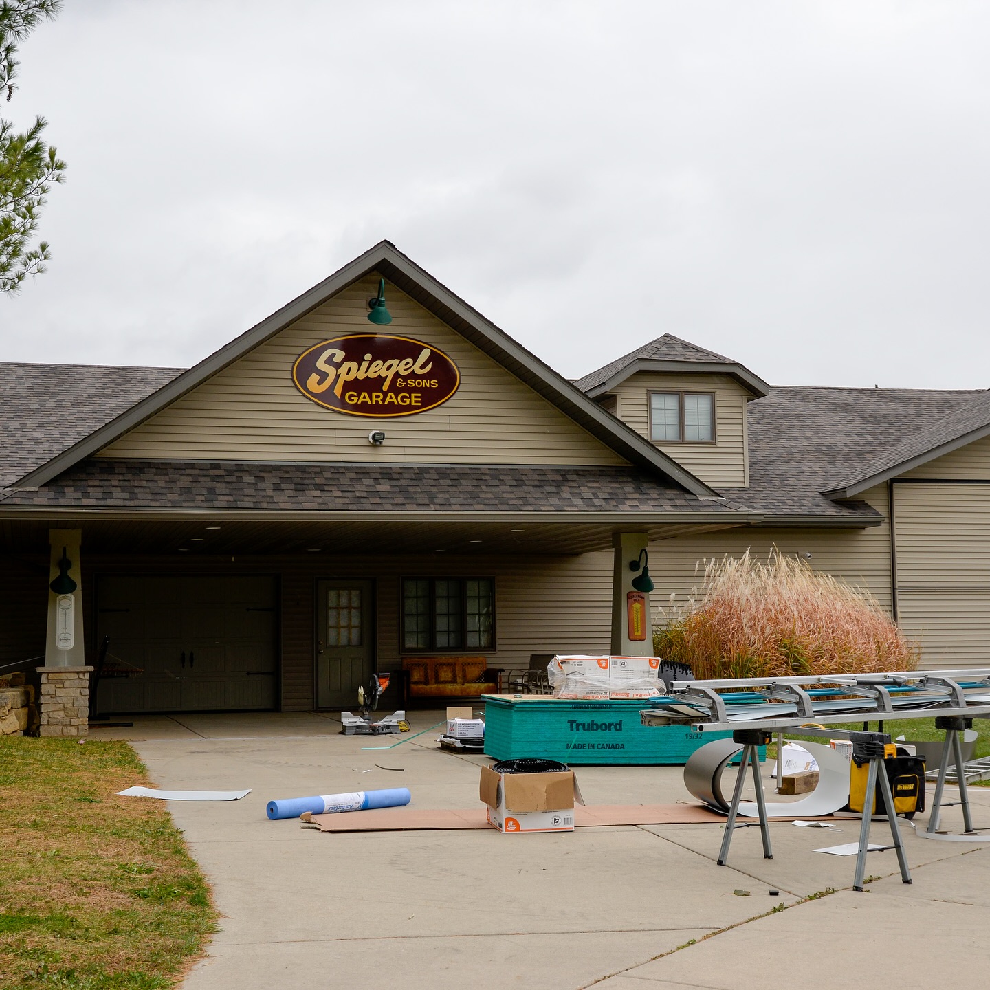 Spiegel and Sons Garage in the Stateline with roofing materials staged in the driveway during an Elite Contracting Group commercial reroof